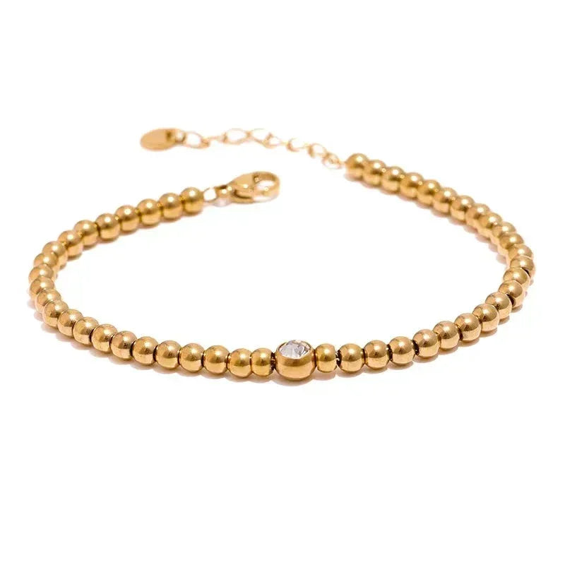 18K gold-plated beaded bracelet with single crystal accent and adjustable chain clasp