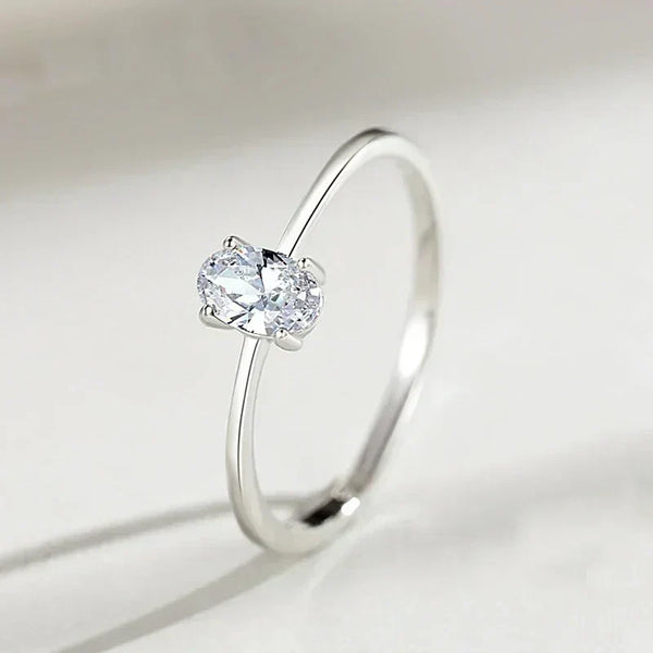 Minimalist 925 silver ring with oval-cut clear gemstone solitaire on white background