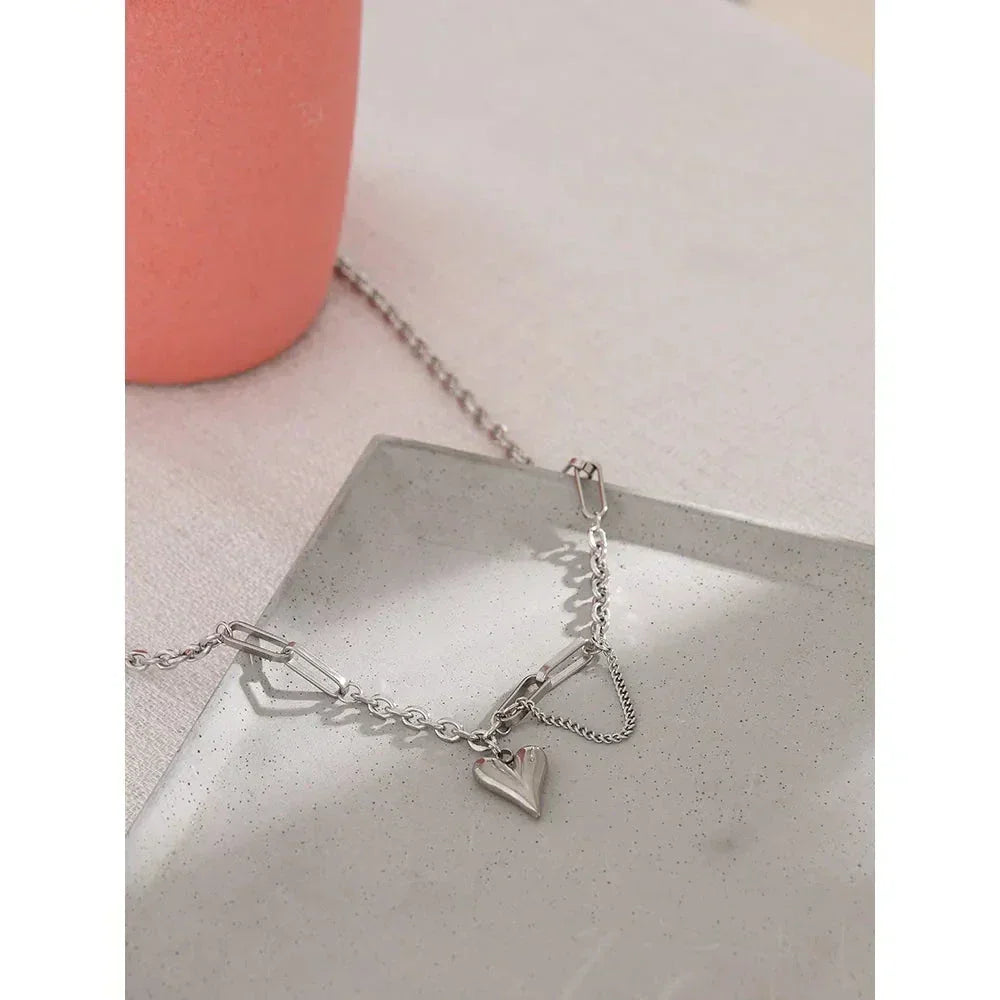 925 silver chain bracelet with heart charm on a neutral tray, elegant jewelry for women