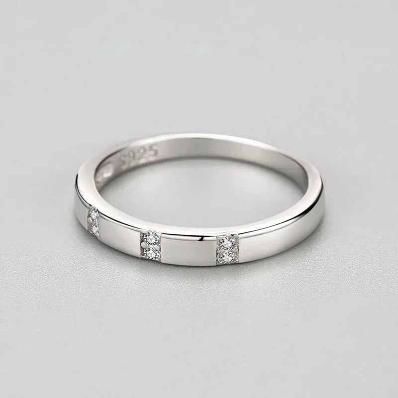 925 silver ring with geometric set cubic zirconia accents on a light gray background