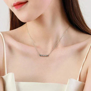 Necklace with small round pendants worn by a model