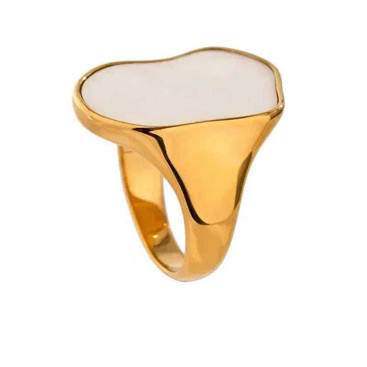 Gold ring with a white stone on a white background
