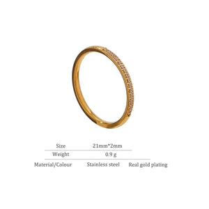 Slim gold-plated stainless steel ring with small clear stones, size 21mm x 2mm.