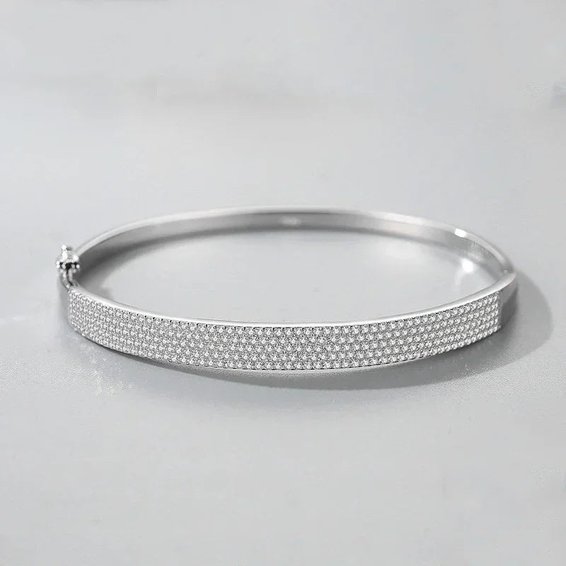 Sterling silver bangle bracelet with pavé-set sparkling crystals on a light background