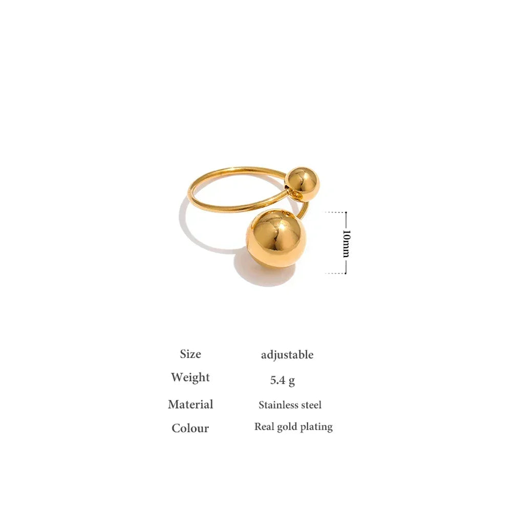 Adjustable gold-plated stainless steel ring with two polished sphere accents, minimalist style.