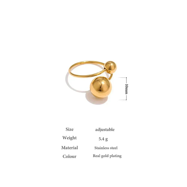 Adjustable gold-plated stainless steel ring with two polished sphere accents, minimalist style.