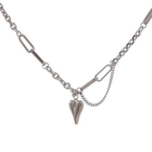 Sterling silver chain necklace with heart pendant and mixed link design on white background