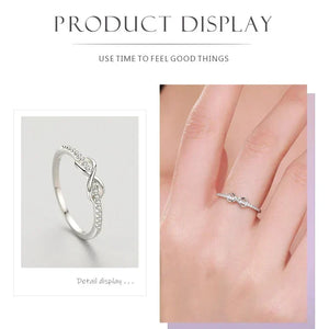 925 sterling silver infinity ring with cubic zirconia accents on white background