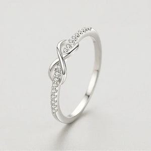925 silver infinity ring with cubic zirconia accents on a light background