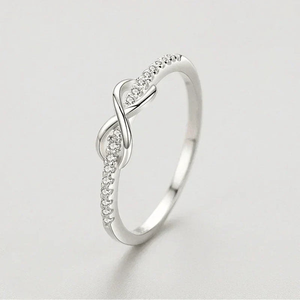 925 silver infinity ring with cubic zirconia accents on a light background