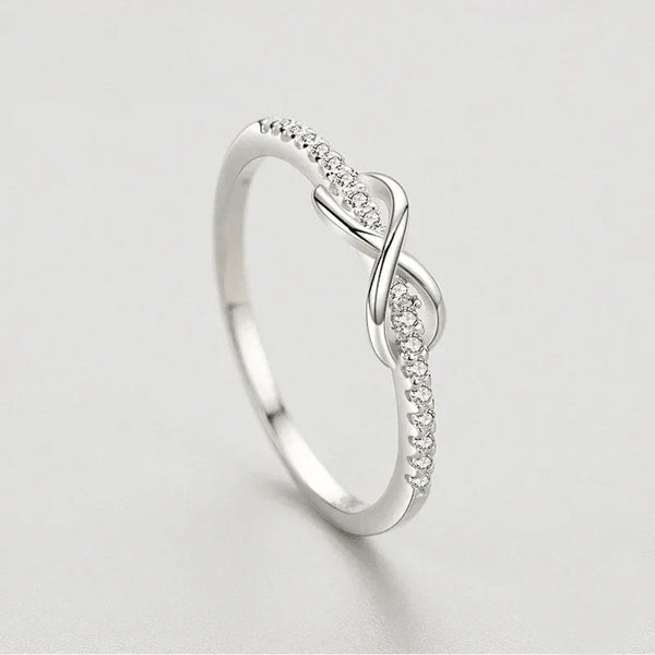 Elegant 925 silver infinity ring with pavé cubic zirconia on a light background