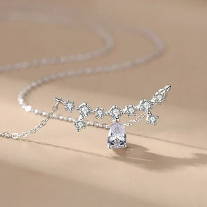 Silver necklace with a teardrop-shaped pendant on a beige background-Crystal Dew Pendant - TM & Co. Jewels.