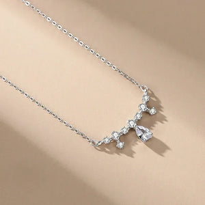 Silver necklace with a star-shaped pendant on a beige background-Crystal Dew Pendant - TM & Co. Jewels.