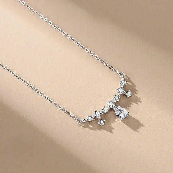 Silver necklace with a star-shaped pendant on a beige background-Crystal Dew Pendant - TM & Co. Jewels.