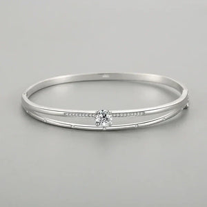 Elegant 925 silver bangle with center round crystal and inset pavé stones, minimalist design