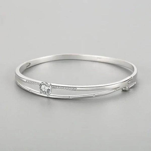 Elegant 925 silver bangle bracelet with sparkling cubic zirconia accents on a gray background