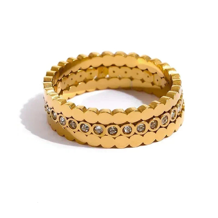Gold ring with diamond accents on a white background