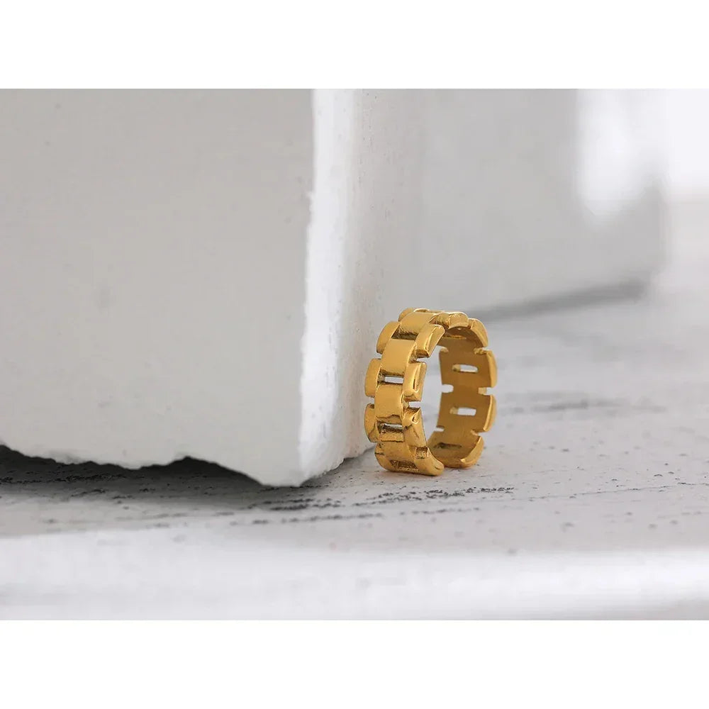 18K gold-plated chunky link ring on textured white surface, modern jewelry design