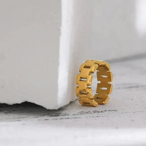18K gold-plated chunky link ring on textured white surface, modern jewelry design
