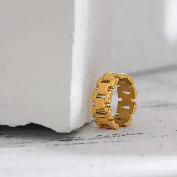 18K gold-plated chunky link ring on textured white surface, modern jewelry design