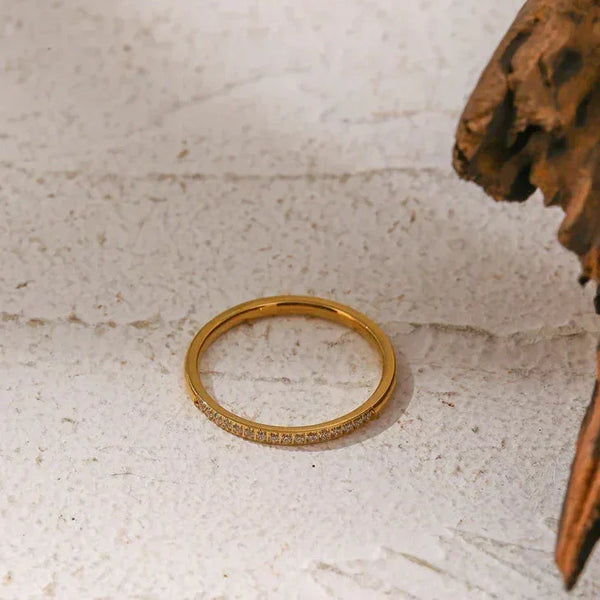 18K gold-plated silver ring with small pavé stones on textured white background