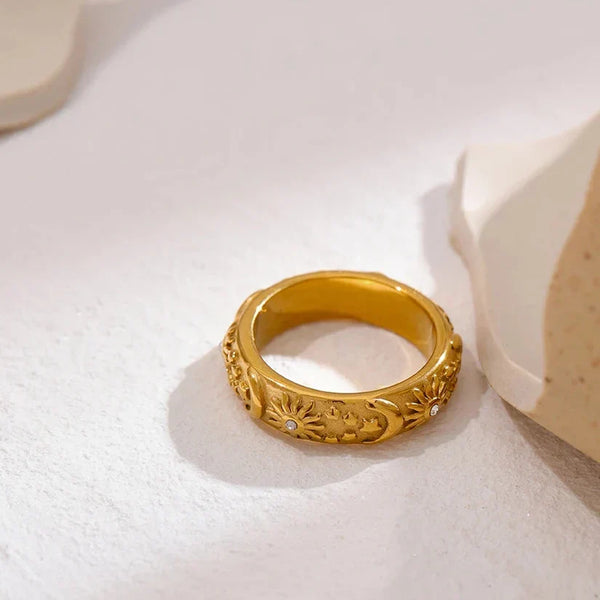 18K gold-plated ring with engraved sun, moon, and star motifs, accented with small crystals