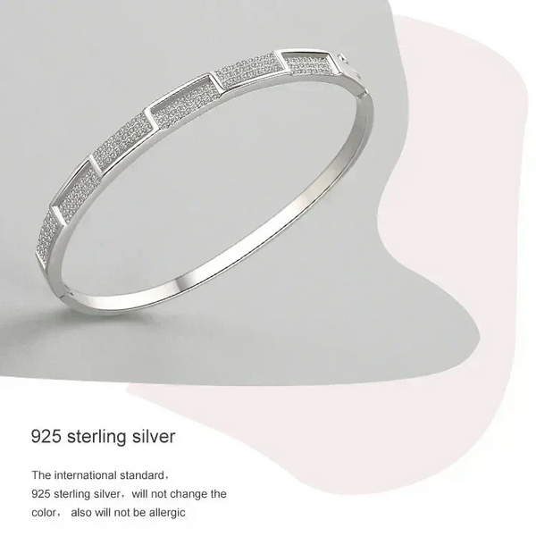 925 sterling silver geometric bangle bracelet with textured panels on neutral background