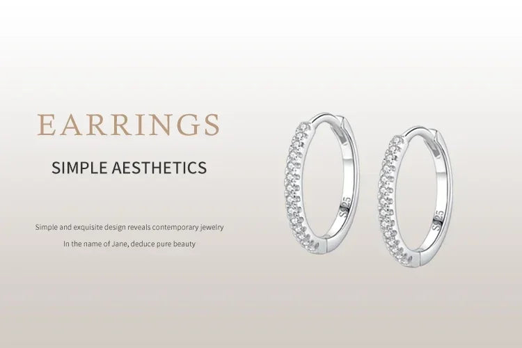 Sterling silver hoop earrings with pavé cubic zirconia, minimalist and elegant jewelry design.
