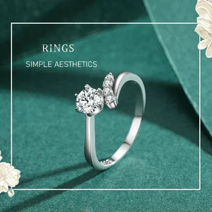 925 silver ring with round-cut center stone and side accent cubic zirconia on a white background