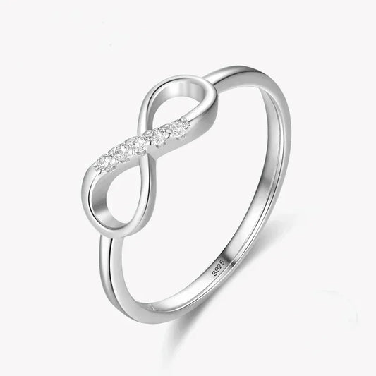 Sterling silver infinity ring with cubic zirconia accents on a white background