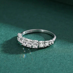Silver ring with diamonds on a green background