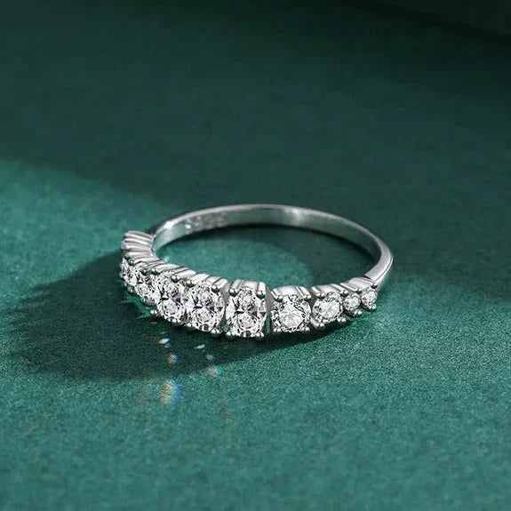 Silver ring with diamonds on a green background