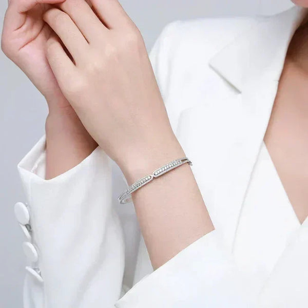 Ava Heart Bands - TM & CO. JEWELS Silver bracelet on a person's wrist with a plain background.