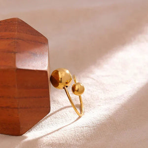 18K gold-plated ring with two polished sphere accents on white background - TM & CO. JEWELS 
