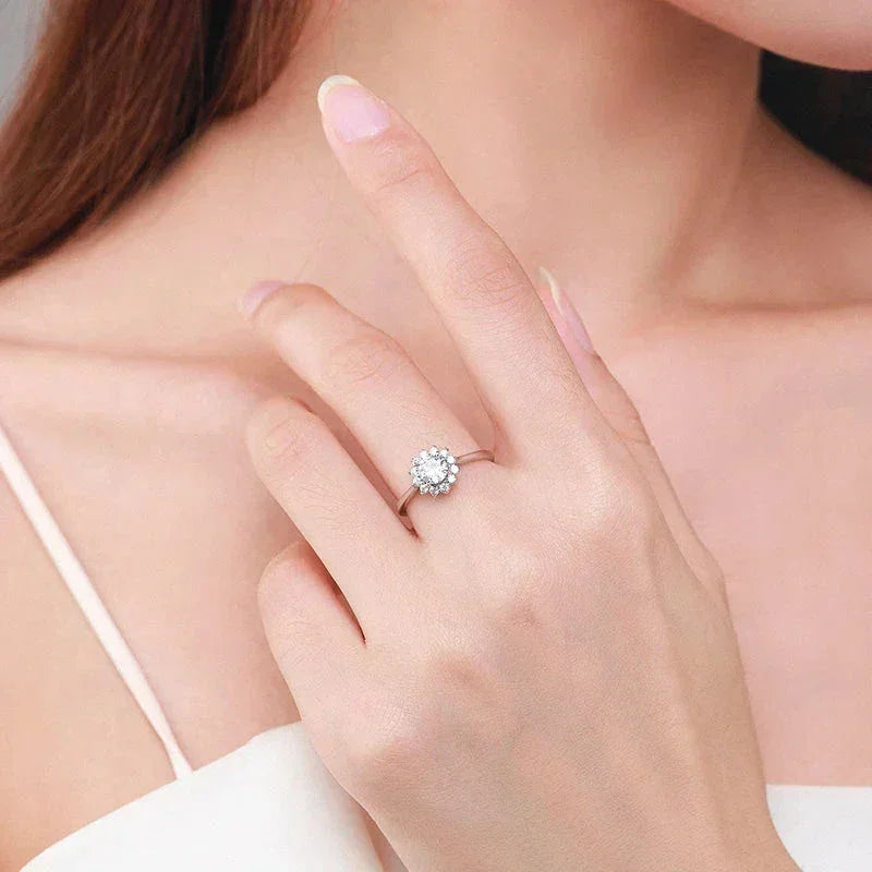 Woman wearing a 925 silver floral cluster ring with sparkling stones on her finger