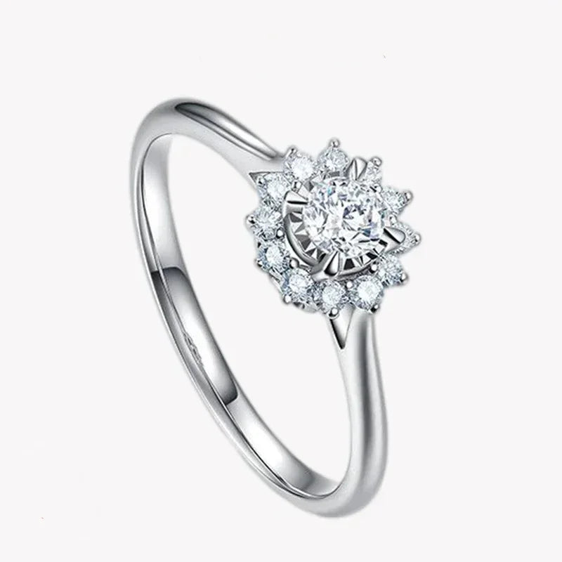 925 silver ring with round halo setting and sparkling clear stones on white background