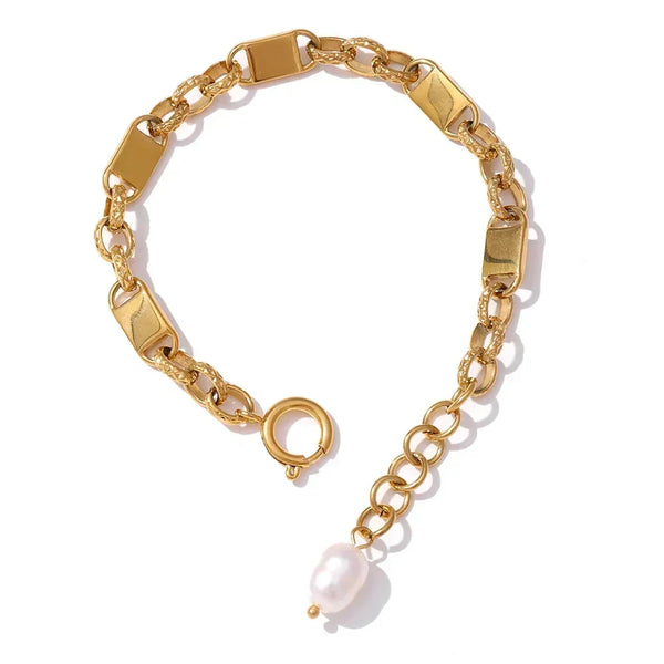 Gold chain bracelet with a pearl charm on a white background