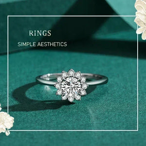 Silver ring with floral design on a teal background