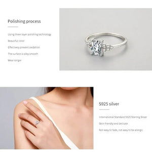 Elegant silver ring with a rectangular clear gemstone and small accent stones on band