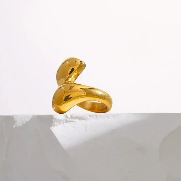 18K gold-plated sculptural open ring for women on white stone background