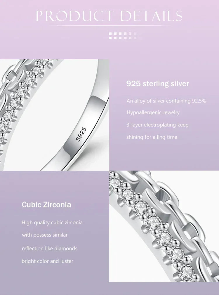 Close-up of 925 sterling silver ring with cubic zirconia stones and chain detail on light background.
