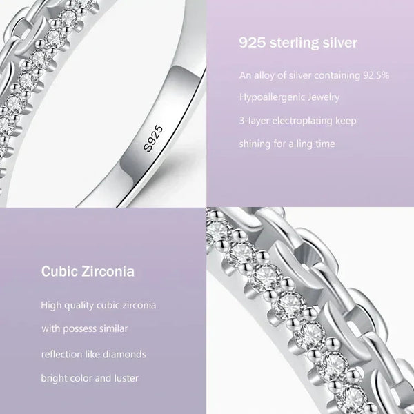 Close-up of 925 sterling silver ring with cubic zirconia stones and chain detail on light background.