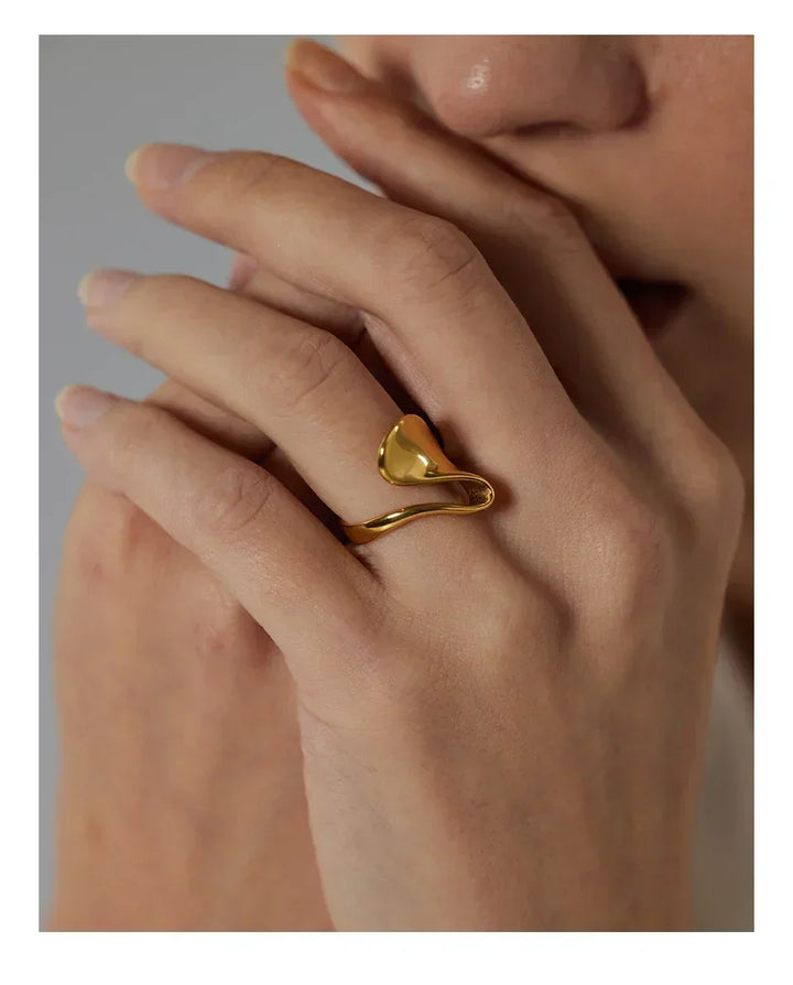 Woman wearing an 18K gold-plated abstract statement ring on her finger