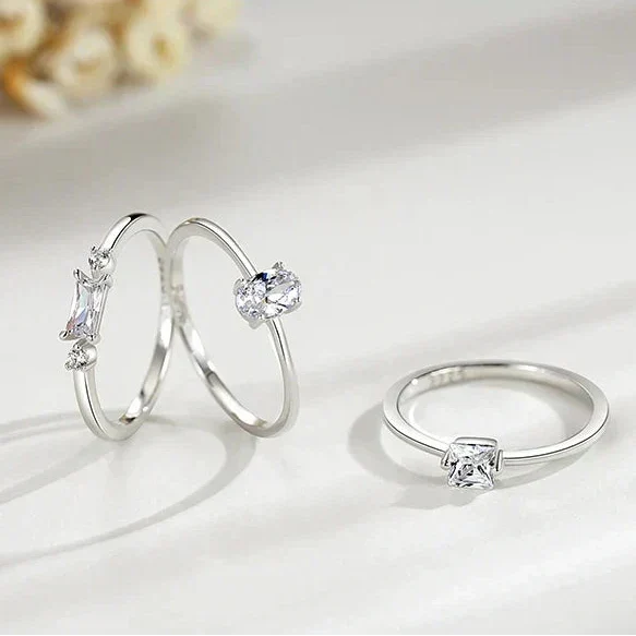 Two silver rings with gemstones on a soft white background