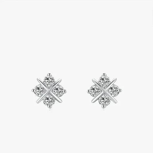 Pair of silver earrings with diamond-like stones on a white background