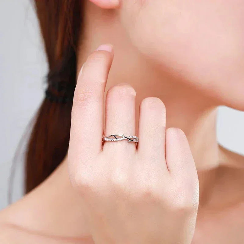 Woman wearing elegant 925 silver twisted band ring with cubic zirconia accents