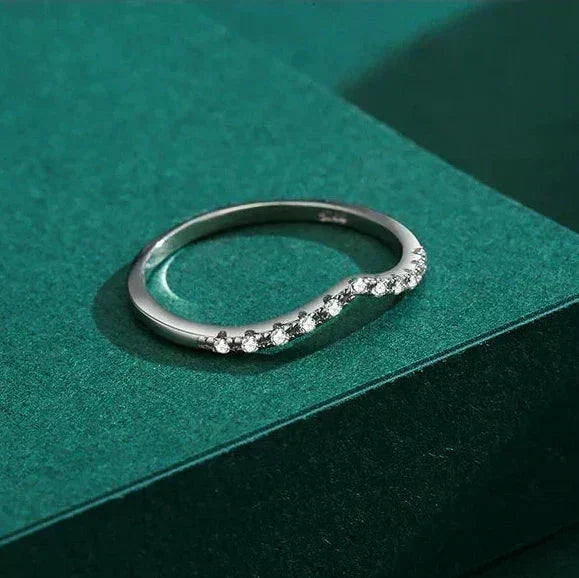 Silver ring with small diamonds on a green box