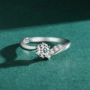 925 silver ring with round-cut center stone and side accent cubic zirconia on a white background