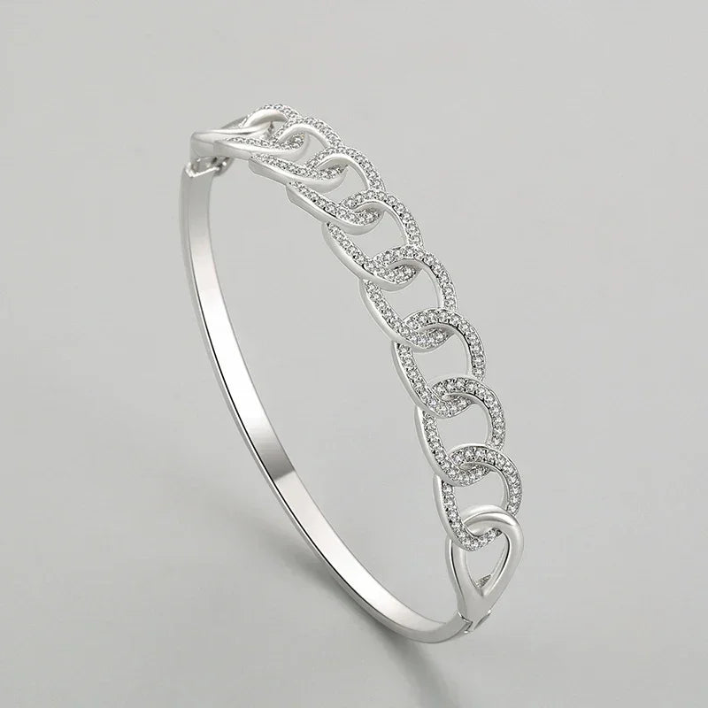 Elegant 925 silver chain link bangle bracelet with cubic zirconia accents on a gray background