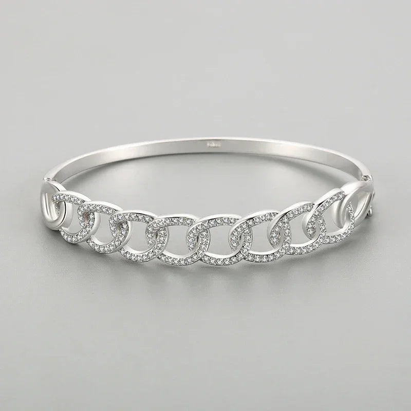 925 silver chain link bangle bracelet with pavé crystals on a gray background